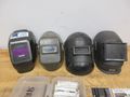 Jackson Auto Darkening Welding Helmet with (3) Older Fixed Shade Helmets and Bin of Tinted and Clear Glass Filler Plates- Auction Item