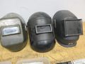 Jackson Auto Darkening Welding Helmet with (3) Older Fixed Shade Helmets and Bin of Tinted and Clear Glass Filler Plates- Auction Item