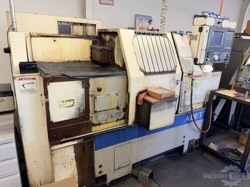 (2) Okuma LNC-8C CNC Lathe, OSP 700L Control, 12 Station Turret, Kitagawa B-08 3 Jaw Chuck, SMW Omnibar Bar Feeder