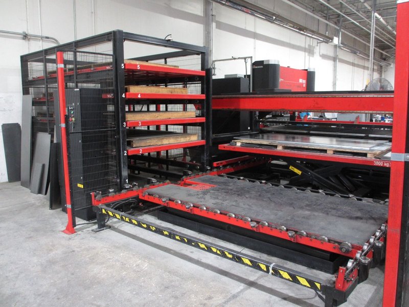 Amada high production punching system with 6 shelf load system and 5 shelf unload with part stacking for unmanned operation with job scheduling